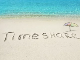 Gordijnen Inscription "Timeshare" in the sand on a tropical island,  Maldi © BRIAN_KINNEY
