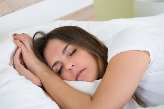 Young Woman Sleeping In Bedroom