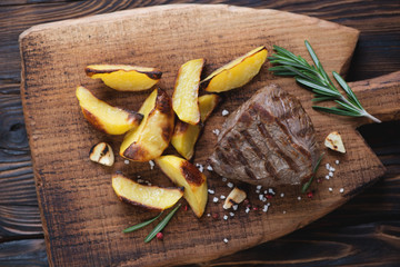 Top view of grilled beef fillet mignon steak with roasted potato