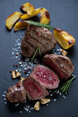 Close-up of rare grilled beef filet mignon steak with potato