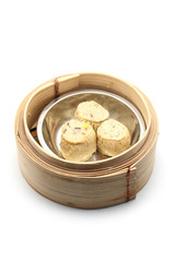 chicken roll in bamboo basket isolated on white