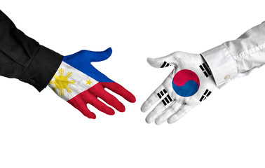 Philippines and South Korea leaders shaking hands on a deal agreement