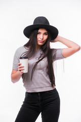 Young attractive woman with rich long brown hair in hat drinking coffee white background.Series of poses.