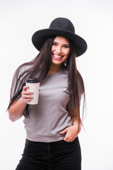 Young attractive woman with rich long brown hair in hat drinking coffee white background. Series of poses.