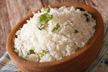Cauliflower rice with basil in a bowl close-up. horizontal