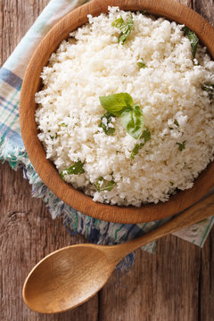 Paleo Food: Cauliflower rice with herbs close-up. Vertical top view
