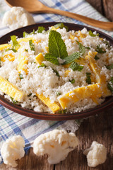 Cauliflower rice with egg and mint for paleo close-up. Vertical
