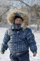 Boy in the hood standing crying in the snow