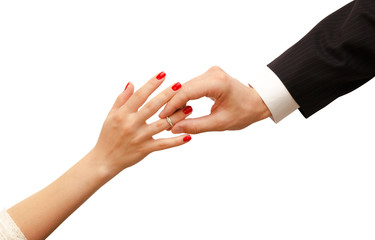 Man putting engagement ring on woman hand isolated. Romantic background with petals, roses, gifts on wooden table.