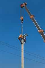 Electricians working in the height with crane .