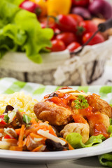 Fried chicken pieces in batter with sweet and sour sauce