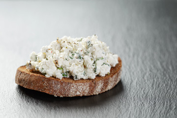 rye sandwich or bruschettarye open sandwich with cream cheese and herbs on slate