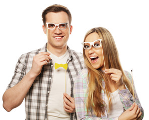 lovely couple holding party glasses on stick