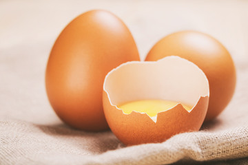 raw chicken eggs on rustic table