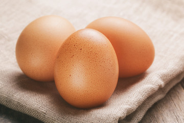 raw chicken eggs on rustic table