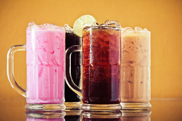 Set of different Asian soft drink, Thai iced lemon tea, Thai iced black tea, Thai iced milk tea, Thai iced black coffee and Thai Iced Pink Milk on table