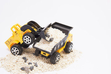 Toy cars are digging shovel into the car