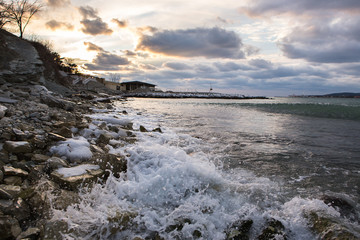 Sea. Ice on the rocks. Cold. Clouds.