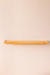 Empty wood shelf on pink wall