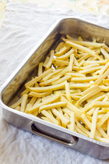 Baking pan of chips to be cooked in the oven