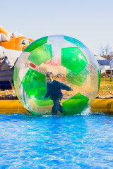 Happy child having fun fun in a Zorbing Ball