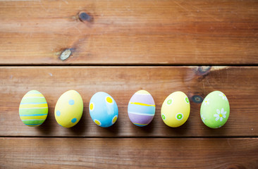 close up of colored easter eggs on wooden surface
