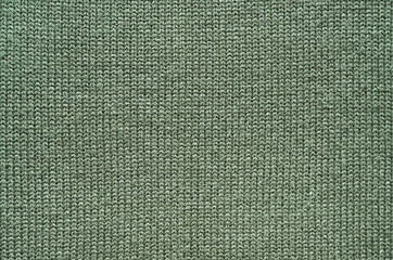 Olive green knitted sweater texture background. Space for copy, text, lettering.