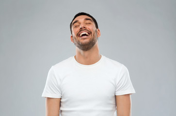 laughing man over gray background