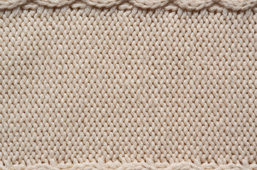 Beige white knitted sweater texture background. Space for copy, text, lettering.