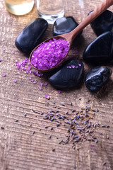 Spa setting. Lavender sea salt and stones on aged  wooden backgr