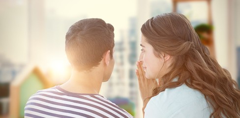 Composite image of woman whispering secret to boyfriend - obrazy, fototapety, plakaty