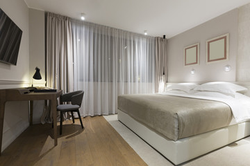 Naklejka na ściany i meble Interior of a luxury hotel bedroom in the evening