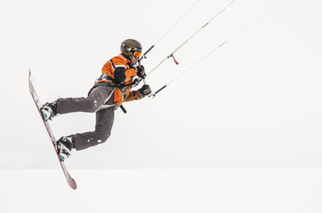 Snowboarder riding a kite