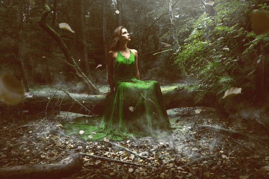 Woman wears a green dress in the forest
