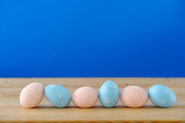 Close up of Easter eggs on a wooden table.