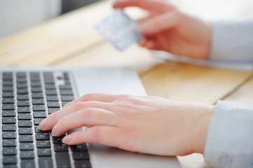 Closeup. Business woman enters the data from the card to the lap