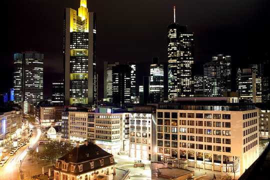 A good view at the Hauptwache in Frankfurt with the Ro&szlig;markt-Street still in use and the illuminated skyline with the Commerzbank-Tower as well as the Main-Tower and Westend