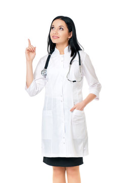 Smiling medical doctor woman with stethoscope showing something