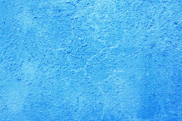 Fototapeta na wymiar Piece of blue wall with plaster as a background