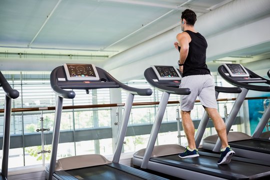 Fit Man Running On Treadmill