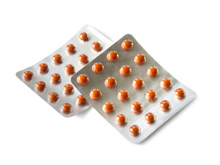 Orange pills in blister packs isolated on white background with