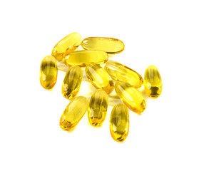 Yellow gelatin pills on white background