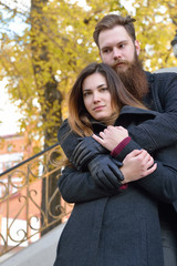 Fototapeta premium Autumn outdoor portrait of young heterosexual couple.