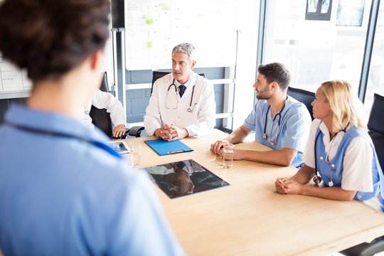Medical team talking together in meeting