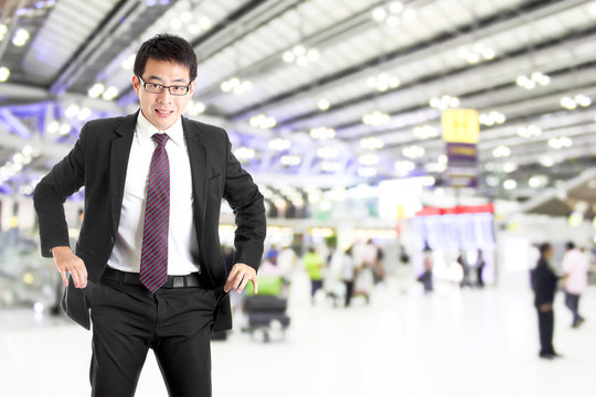 poor businessman show empty pocket with blur airport background