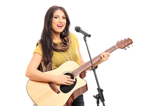 Female signer playing on acoustic guitar