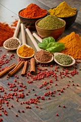 Poster Variety of spices on kitchen table © monticellllo