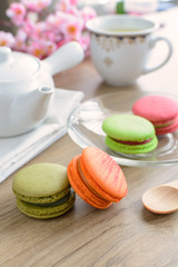 Fototapeta na wymiar Cup of tea with colorful macaroons