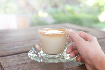 Hand holding coffee cup