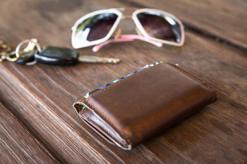Old leather wallet on wood table
